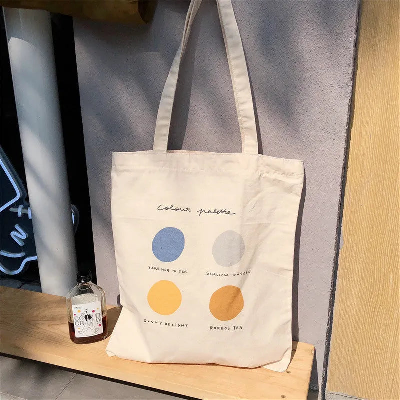 Light pink women's canvas tote bag with geometric pattern, showing zipper and double soft handles.