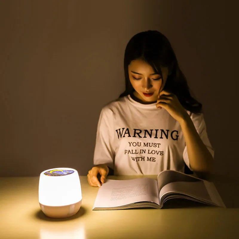 Pruixin PRX1363 LED projector night light showing starry sky or love pattern projection on a bedroom wall.