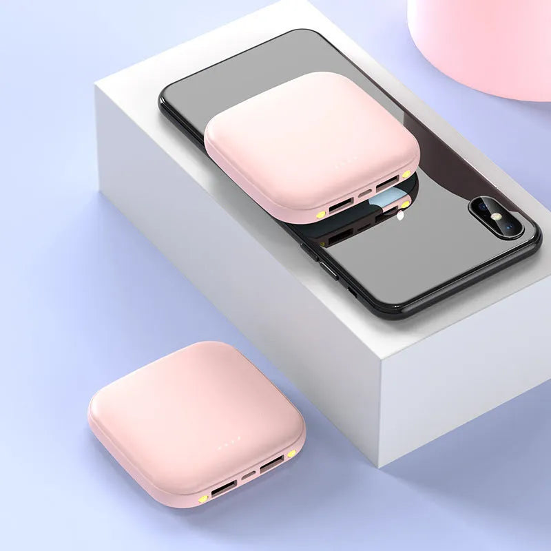 Square black mini power bank showing size scale with built-in LED flashlight and USB port