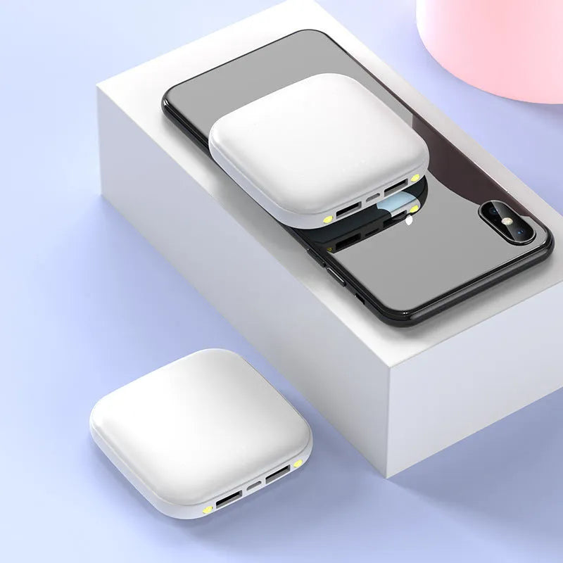Square black mini power bank showing size scale with built-in LED flashlight and USB port
