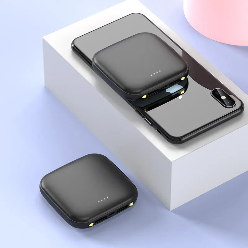 Square black mini power bank showing size scale with built-in LED flashlight and USB port