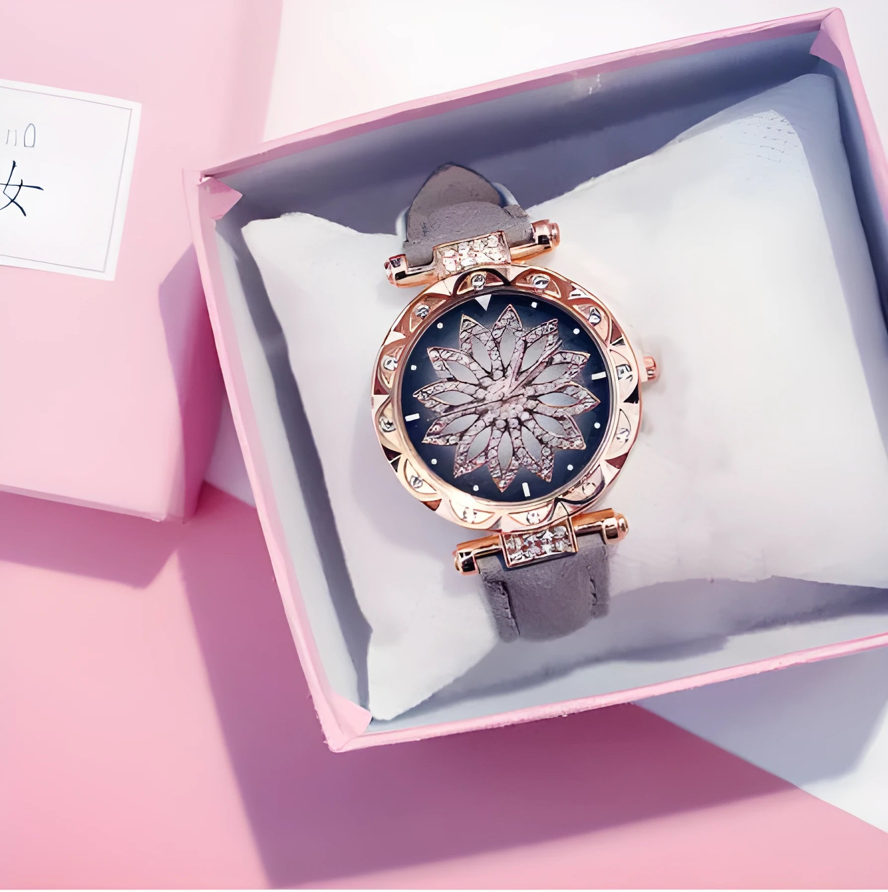 Full diamond bezel ladies watch with round dial on wrist, showing colour options and pin buckle clasp.