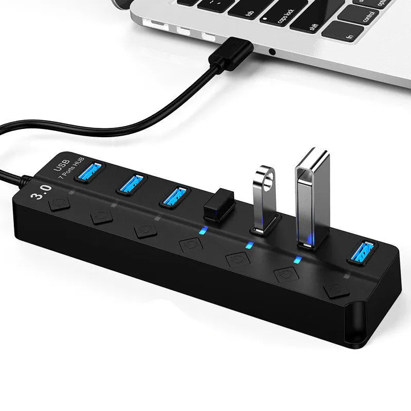 Black 7-port USB 3.0 hub with external power supply on desktop