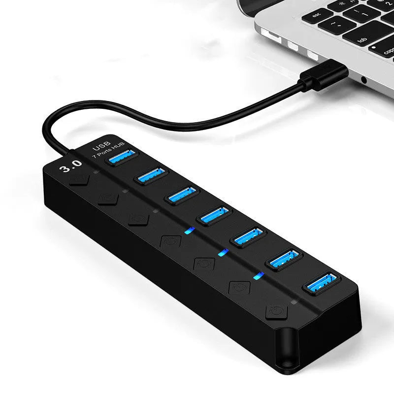 Black 7-port USB 3.0 hub with external power supply on desktop