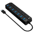 Black 7-port USB 3.0 hub with external power supply on desktop