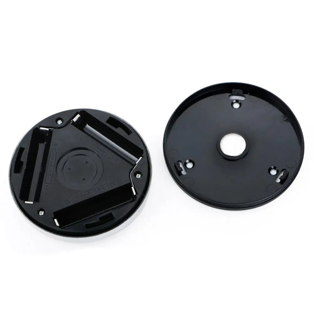 Silver-coloured circular wireless motion sensor night light on a surface