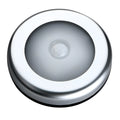 Silver-coloured circular wireless motion sensor night light on a surface