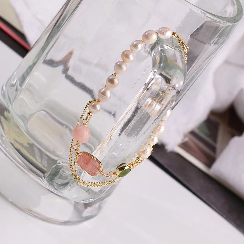 Women's pink freshwater pearl bracelet with geometric strawberry crystal pendant on individual packaging