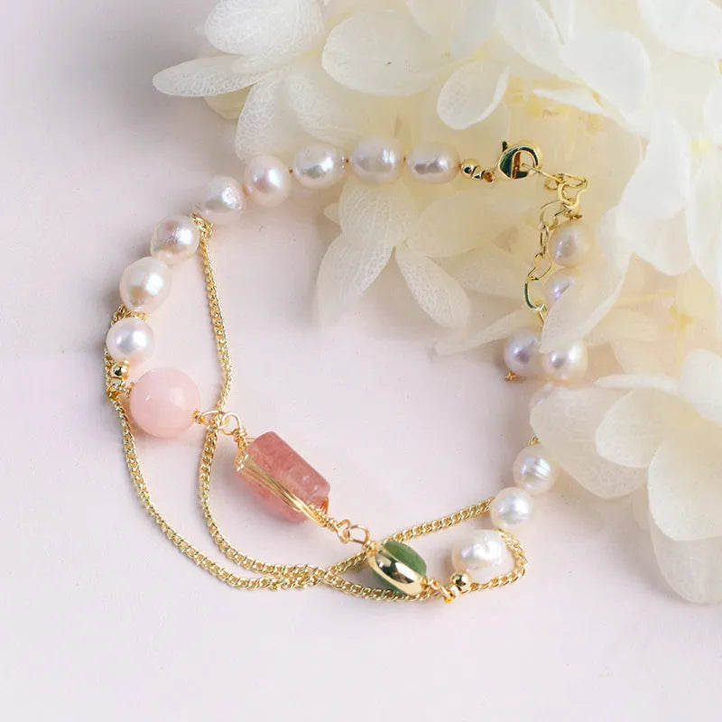 Women's pink freshwater pearl bracelet with geometric strawberry crystal pendant on individual packaging