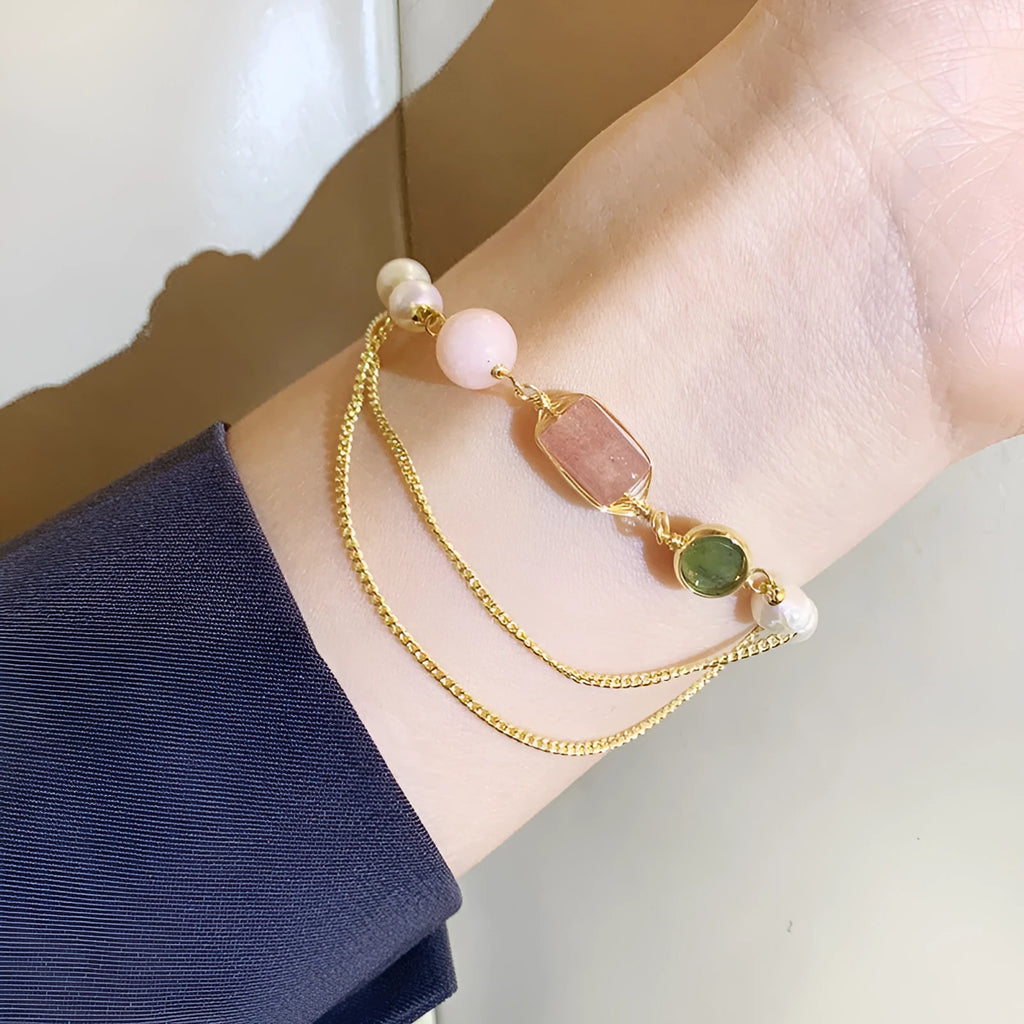Women's pink freshwater pearl bracelet with geometric strawberry crystal pendant on individual packaging