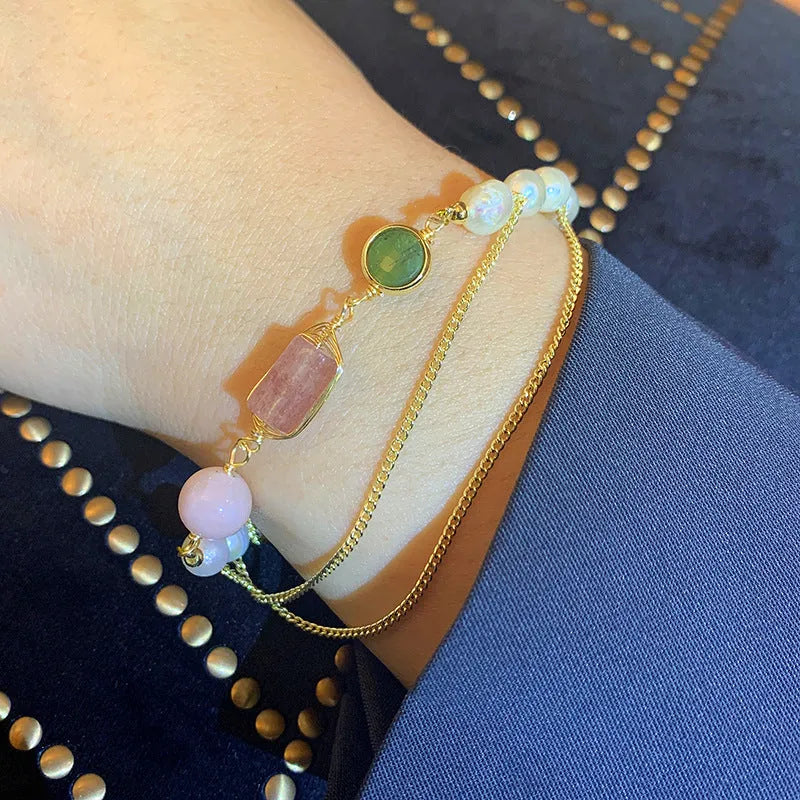 Women's pink freshwater pearl bracelet with geometric strawberry crystal pendant on individual packaging