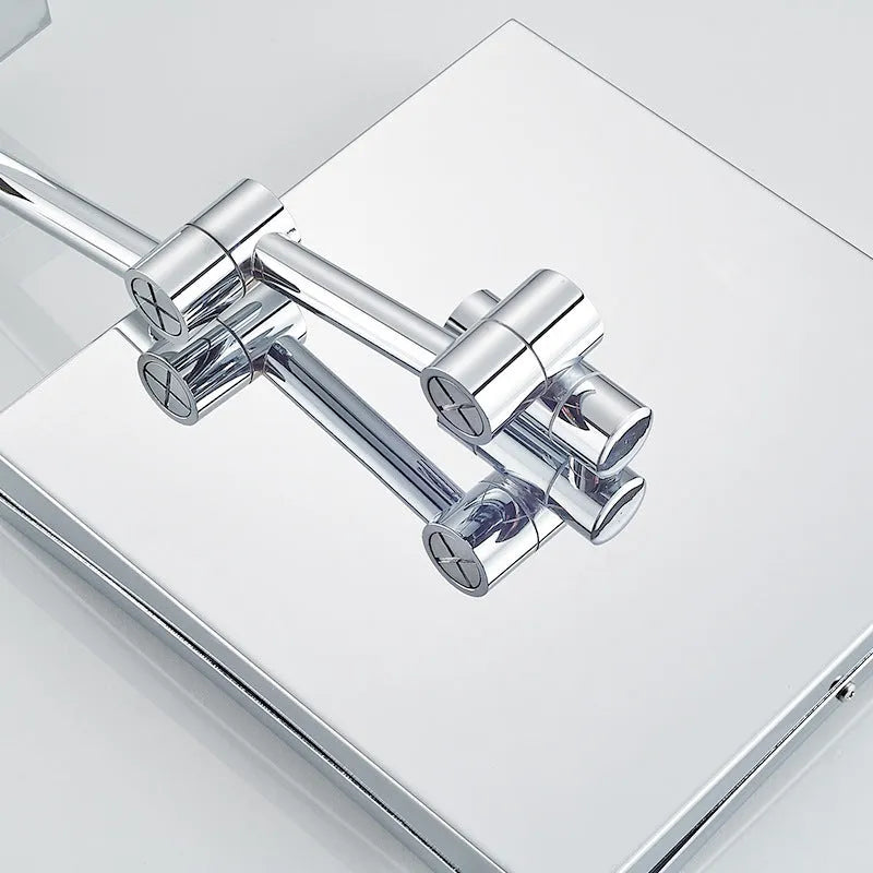 Stainless steel folding bathroom makeup mirror measuring 8.5 inches square in a choice of four finishes.