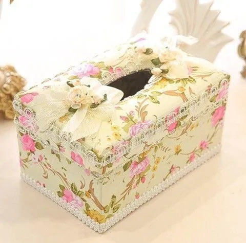 Ceramic jewellery and tissue storage box in bright apricot, holding rings and a tissue pack.