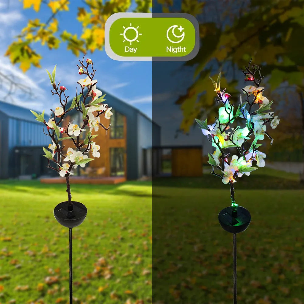 Solar cherry tree garden decoration light with ground insert spike on a lawn.