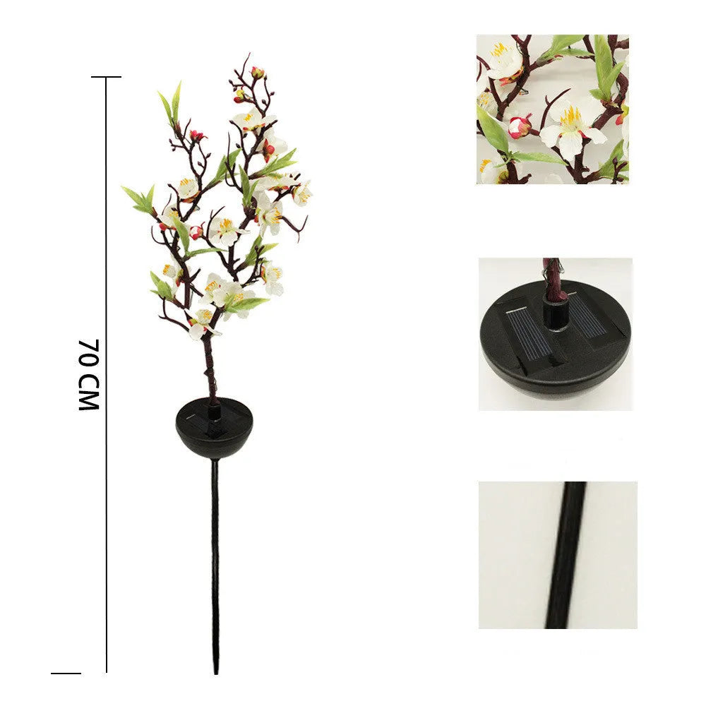 Solar cherry tree garden decoration light with ground insert spike on a lawn.