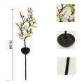 Solar cherry tree garden decoration light with ground insert spike on a lawn.