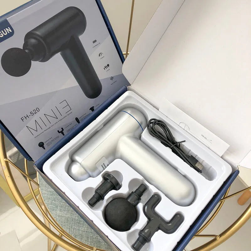 Black handheld muscle massage gun with percussion head showing USB charging port