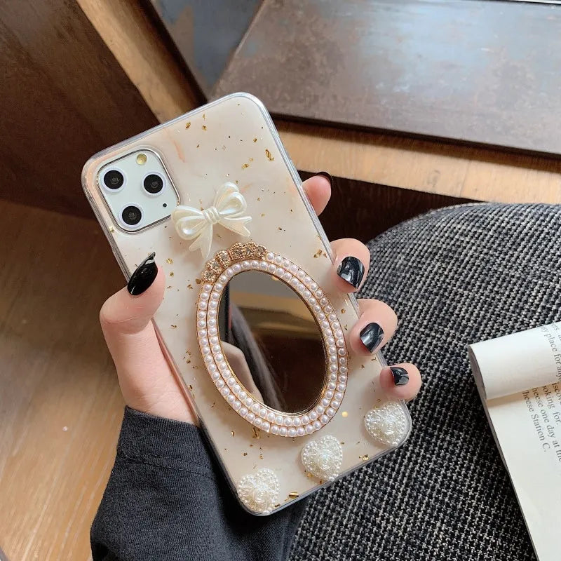 Brown marble patterned silicone iPhone case with a mirror back and a rhinestone bowknot decoration.
