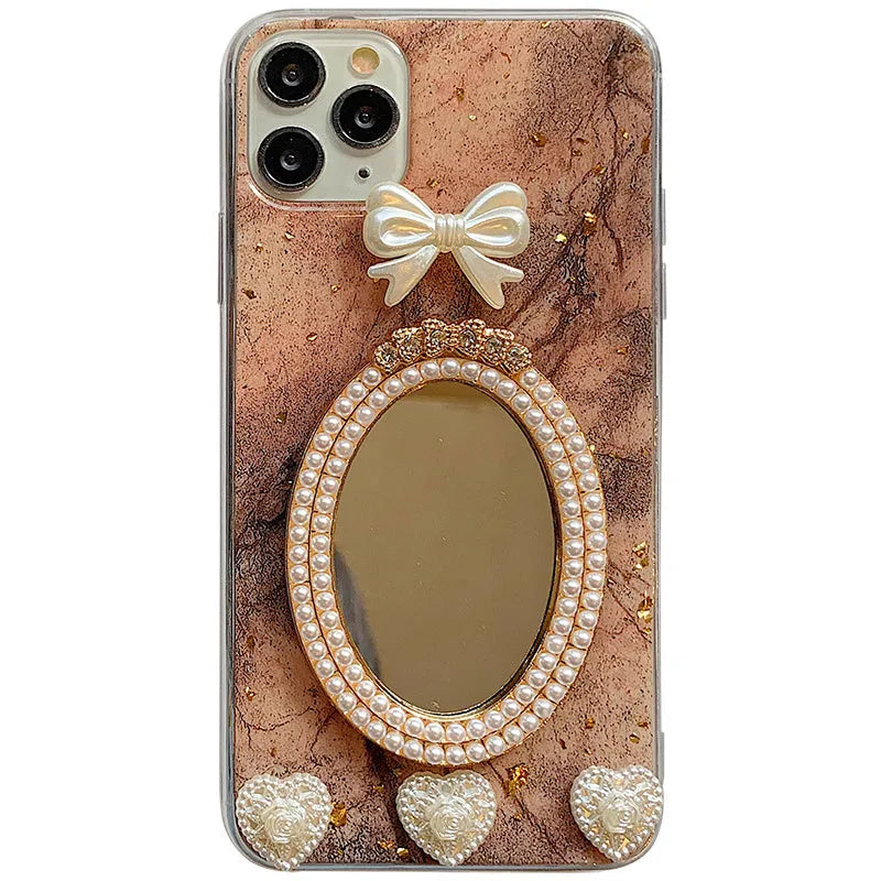 Brown marble patterned silicone iPhone case with a mirror back and a rhinestone bowknot decoration.