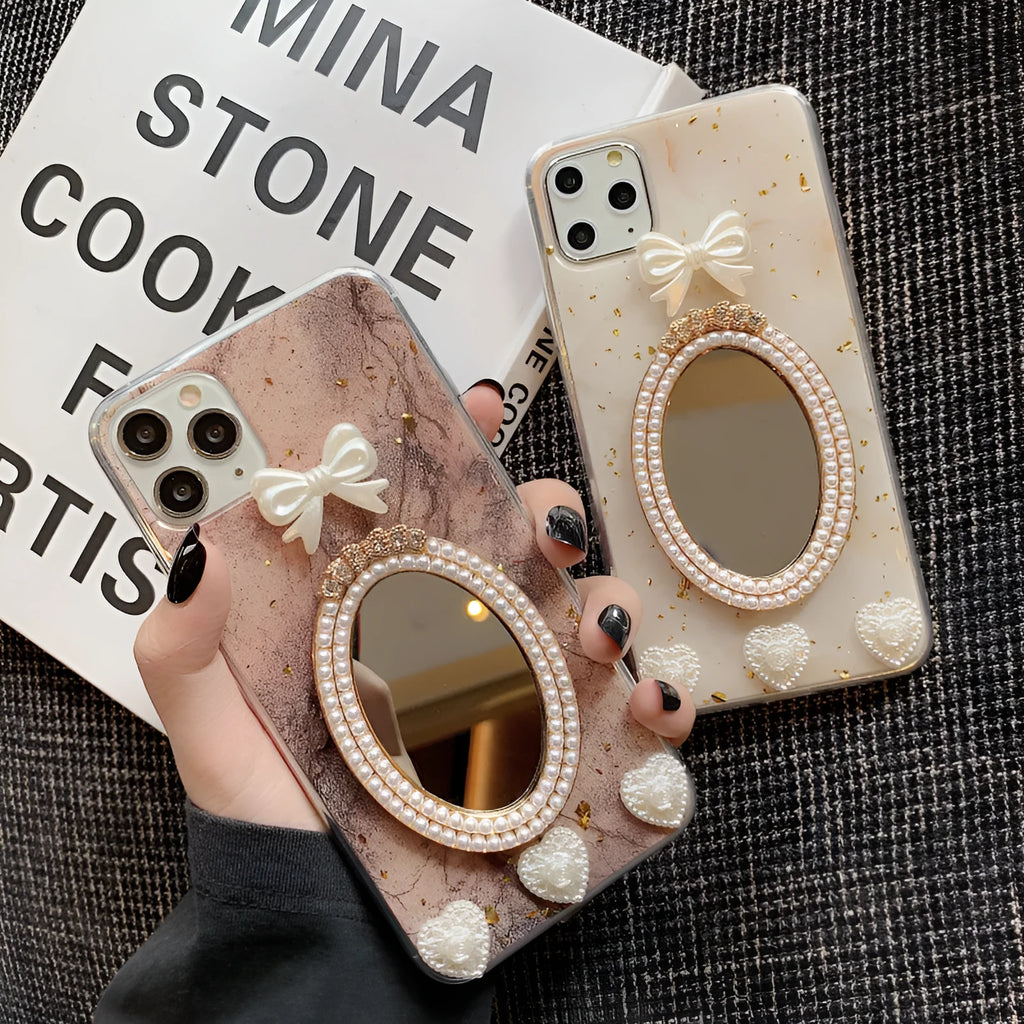 Brown marble patterned silicone iPhone case with a mirror back and a rhinestone bowknot decoration.