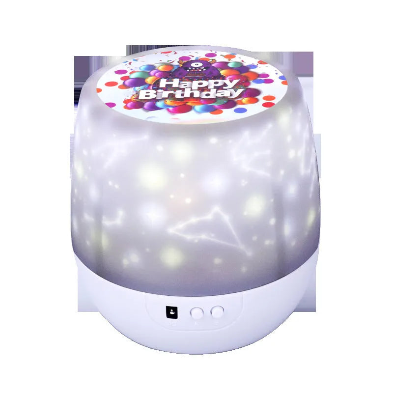 Compact plastic starry sky projection lamp showing cosmos and constellation film options on a table.