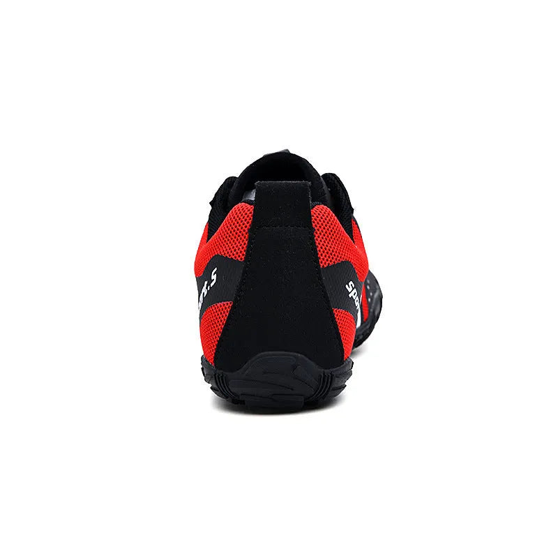 Outdoor quick-dry wading shoes in red with mesh upper and rubber sole on a rocky shore