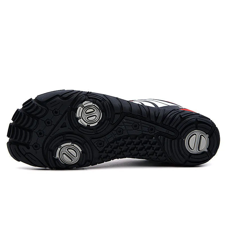 Outdoor quick-dry wading shoes in red with mesh upper and rubber sole on a rocky shore