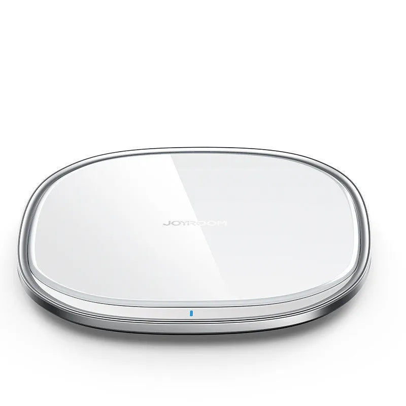 Slim black 15W Qi wireless charger with a zinc alloy frame and glass top on a wooden desk.