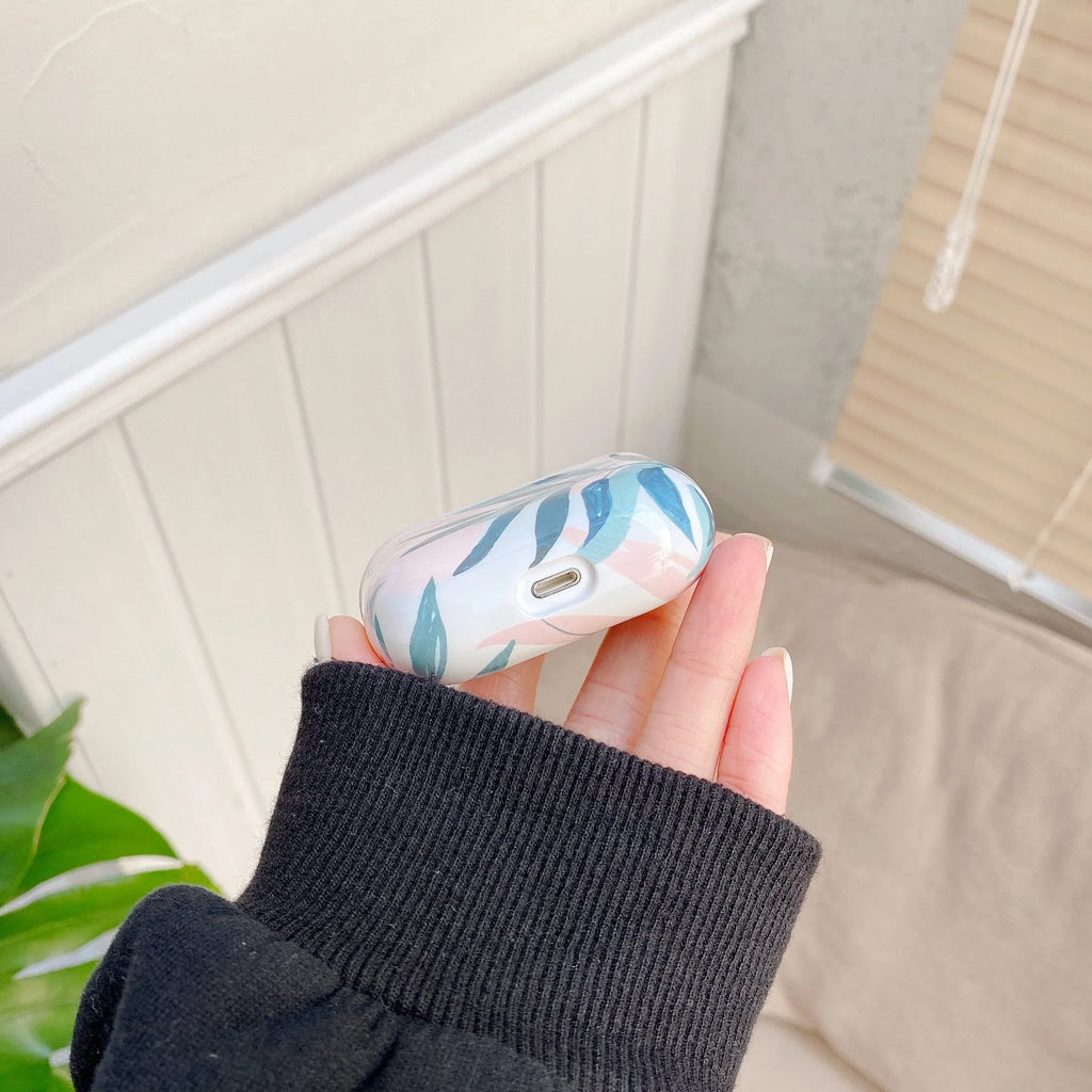 Blue and green TPU AirPods cases with banana leaf pattern for AirPods 1, 2, and Pro models.
