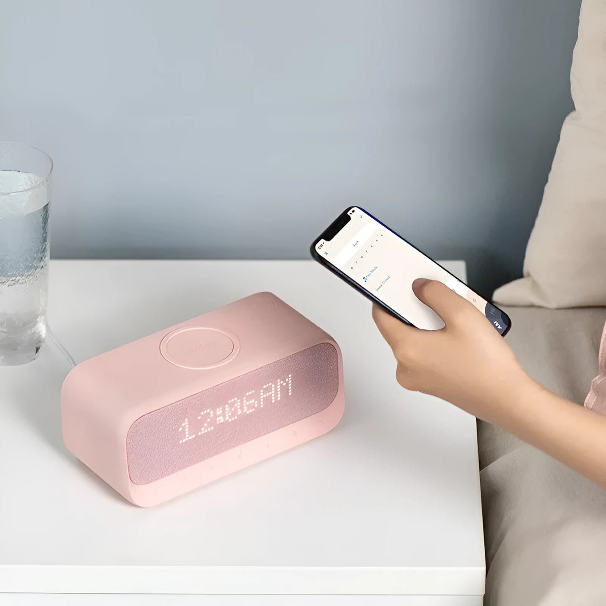 Anker Soundcore white Bluetooth speaker with wireless charging pad and alarm clock display