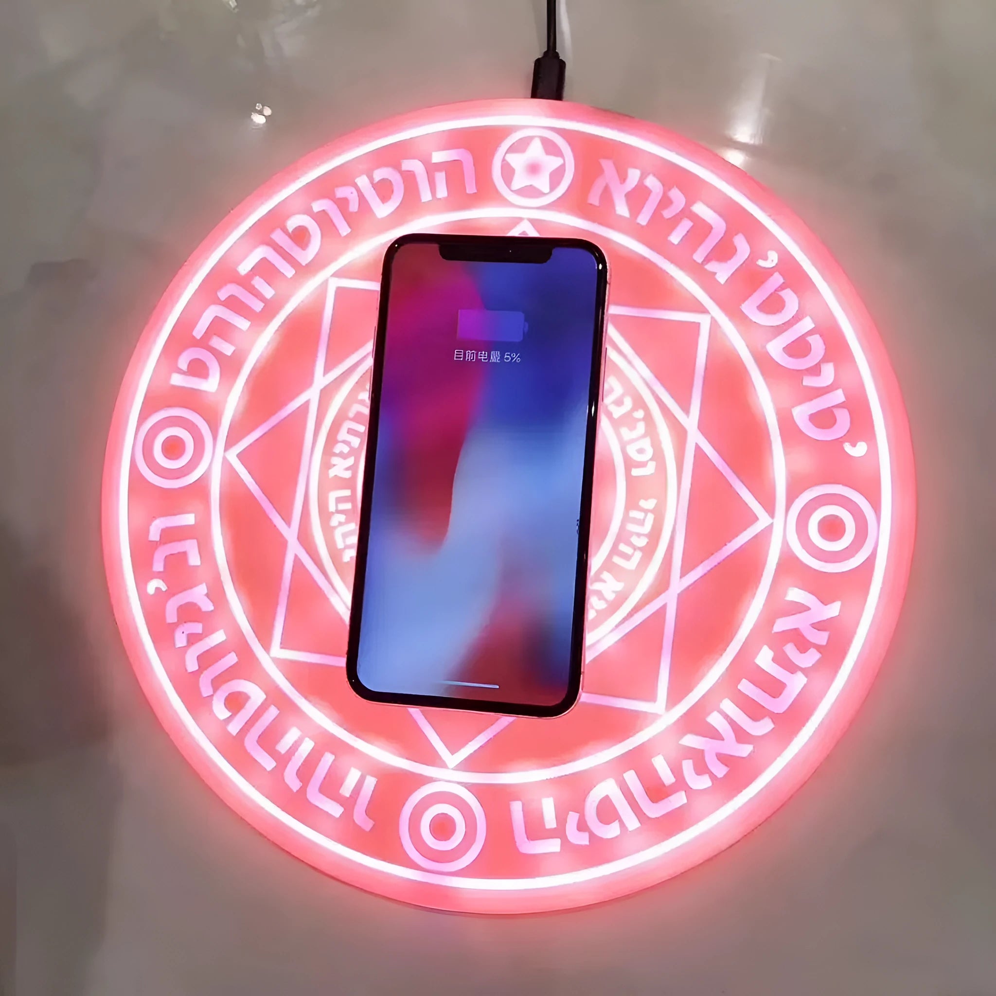 Square wireless charger with glowing magic array pattern design on desk