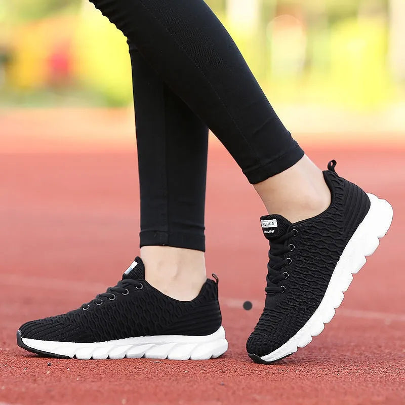 Women's running shoes with fly weaving upper in black, pink or white colours showing breathable construction