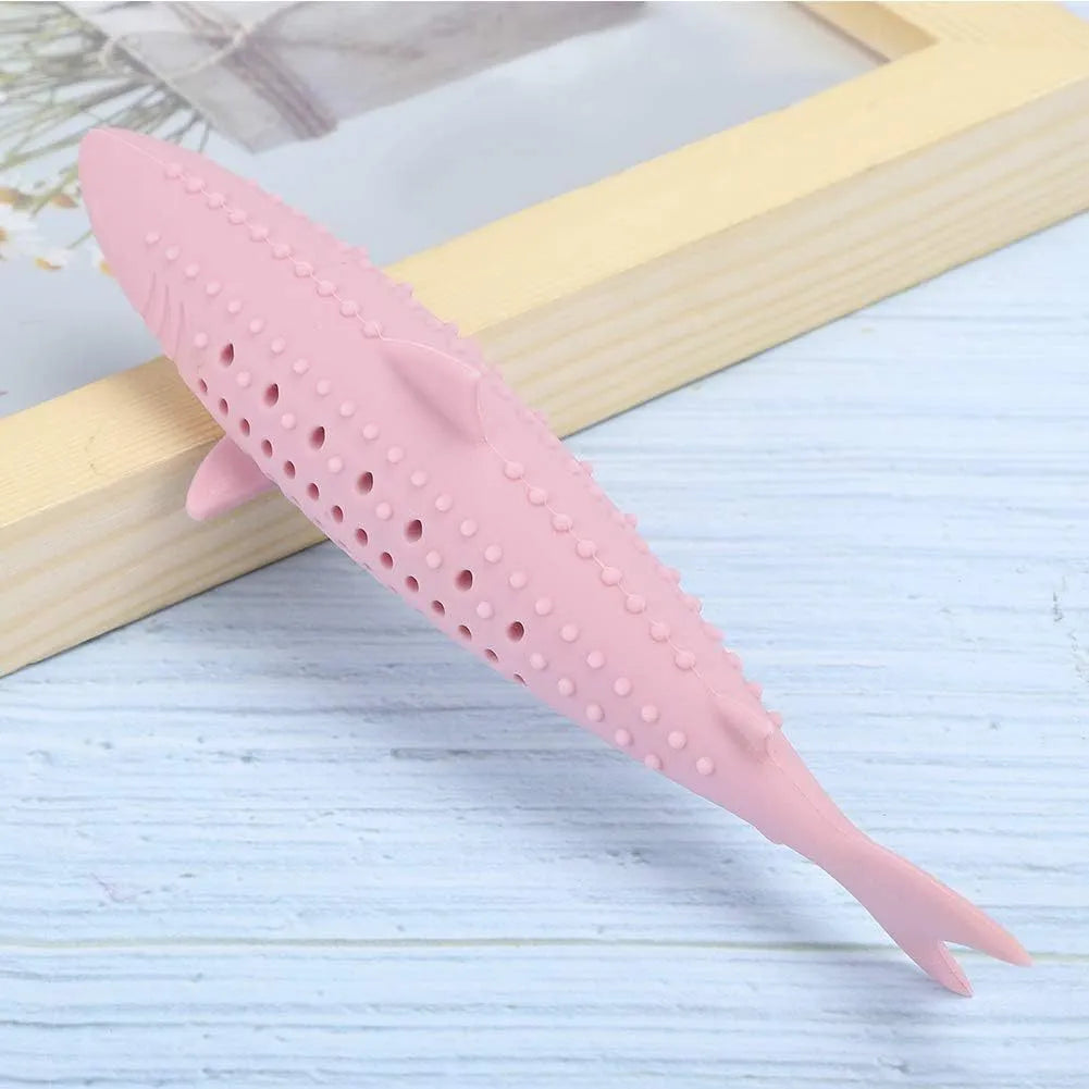 Green silicone fish-shaped cat chew toy with dolphin details and visible side holes.