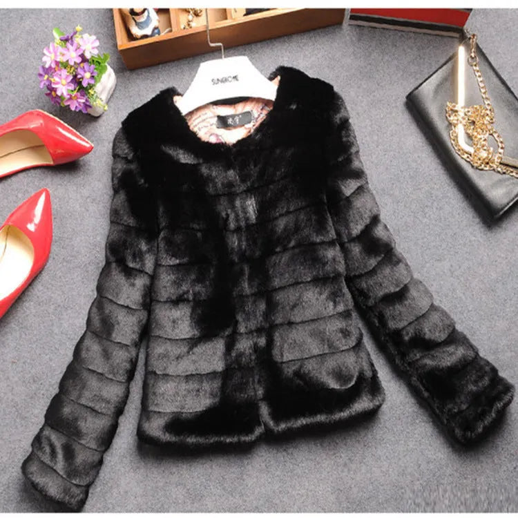A woman's short faux fur top in beige, shown on a hanger.