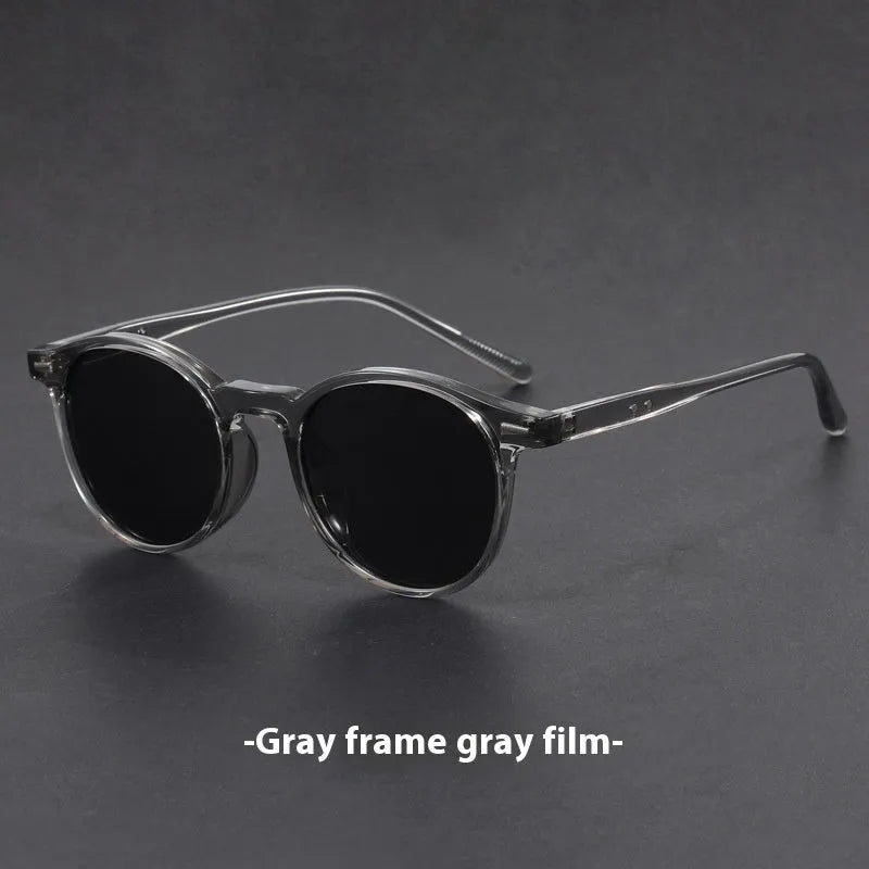 Retro oval round frame sunglasses with grey polarised lenses shown in sand black frame colour.