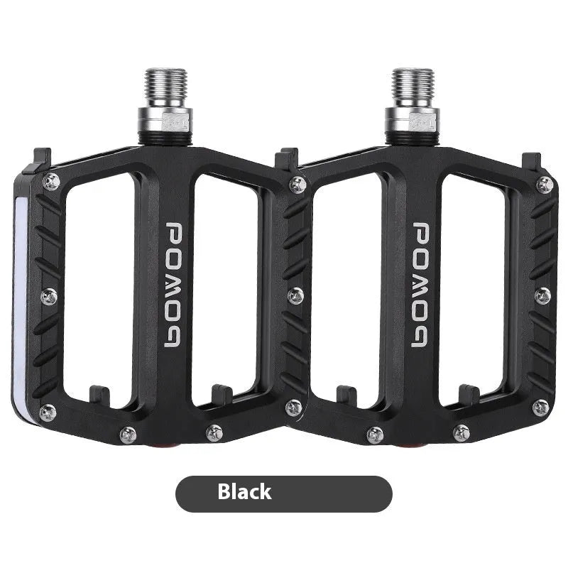 Bicycle pedal with integrated LED lights in aluminium alloy construction showing colour options