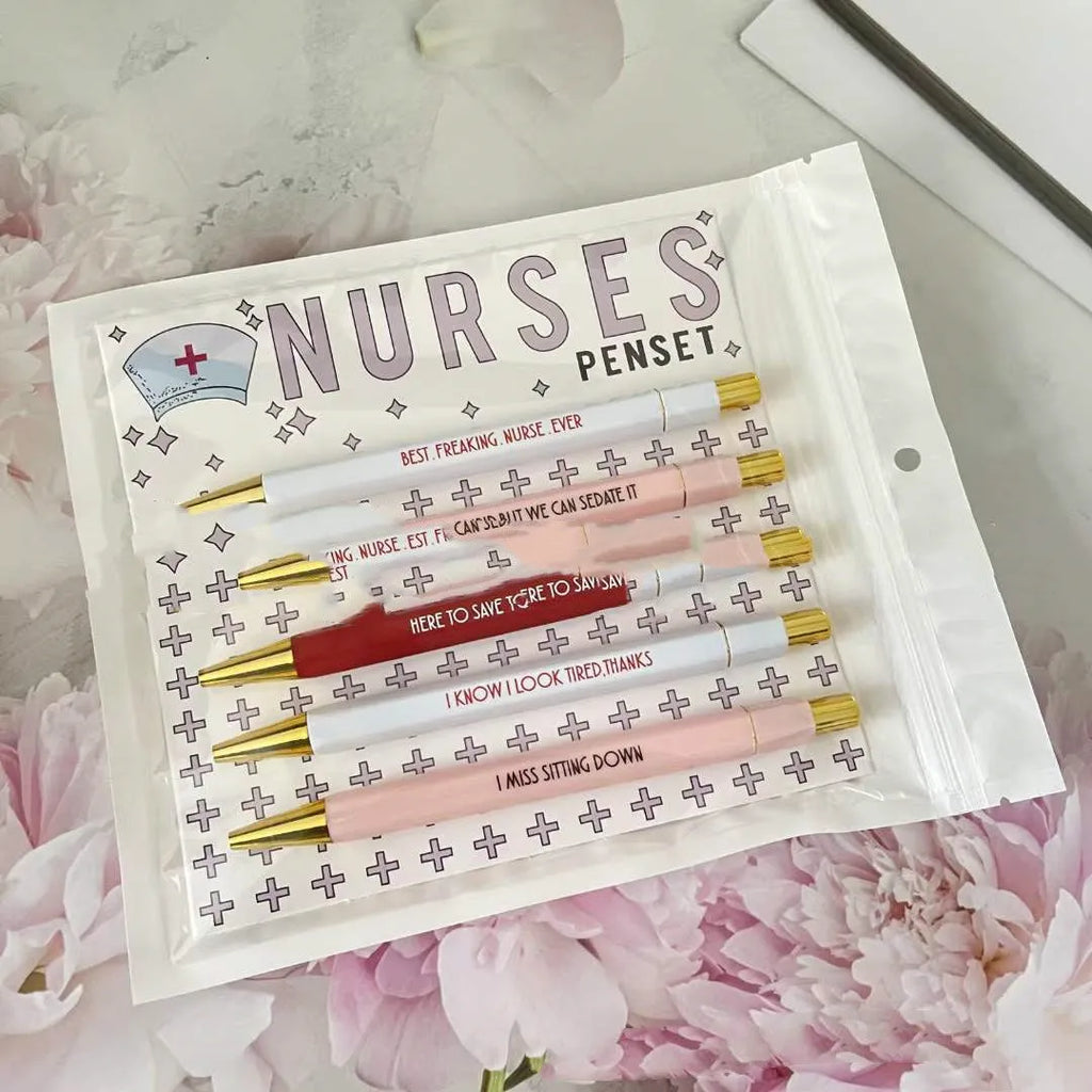 Five nurse-themed retractable ballpoint pens with medical motif designs arranged together