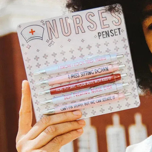 Five nurse-themed retractable ballpoint pens with medical motif designs arranged together