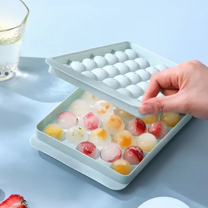 Blue round ice cube tray with 33 moulds and transparent lid