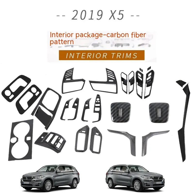 Black ABS plastic centre console trim panel for BMW X5 2019 G05 model with integrated cup holders.