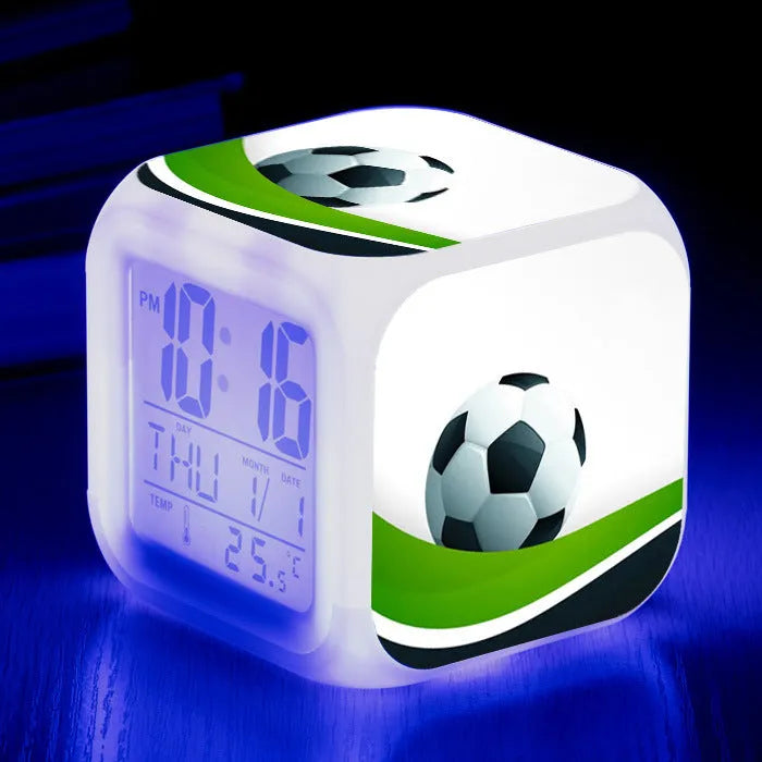 Square cartoon alarm clock with a football pattern design, showing a four-sided mute alarm for children.