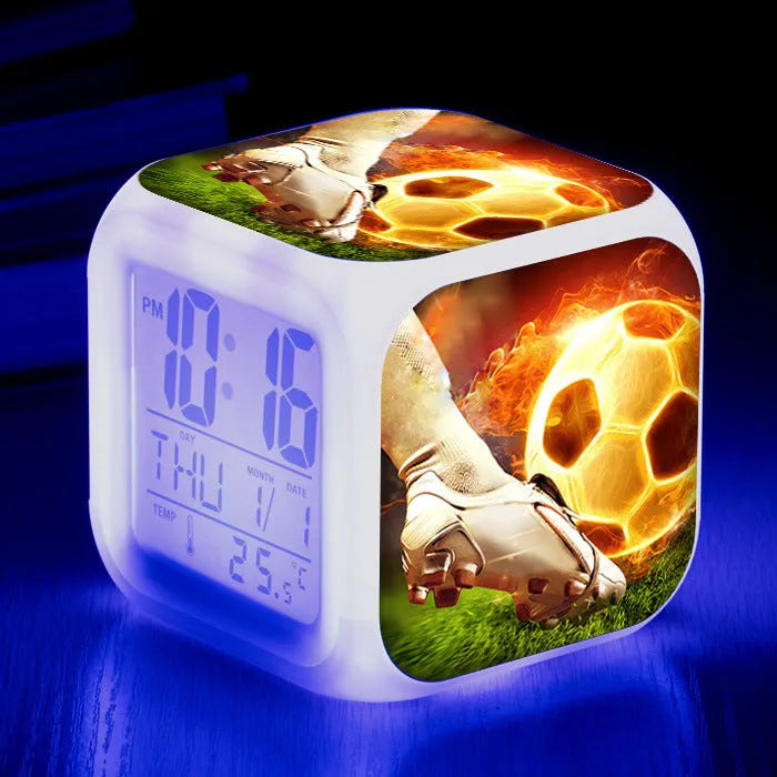 Square cartoon alarm clock with a football pattern design, showing a four-sided mute alarm for children.