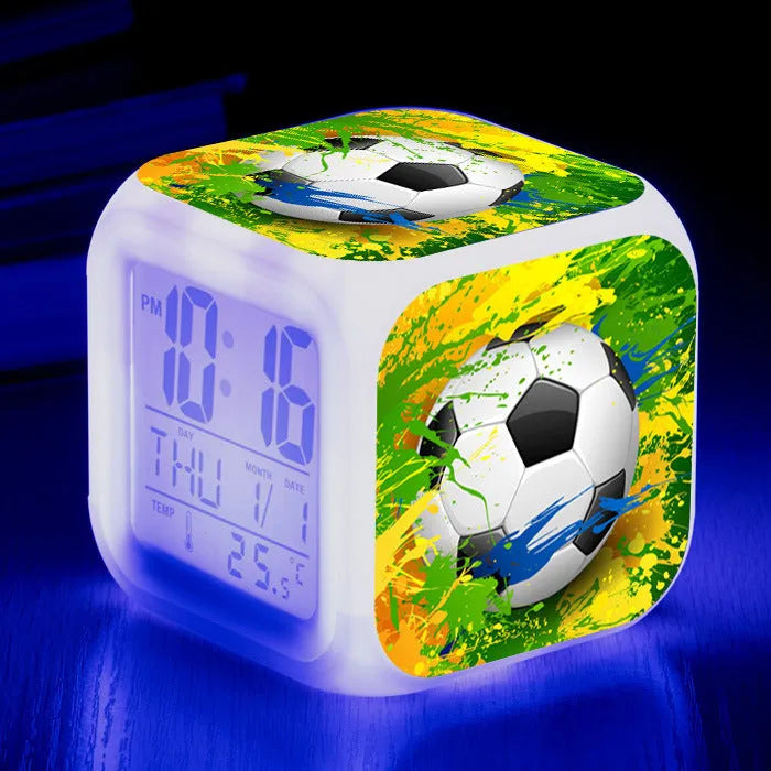Square cartoon alarm clock with a football pattern design, showing a four-sided mute alarm for children.