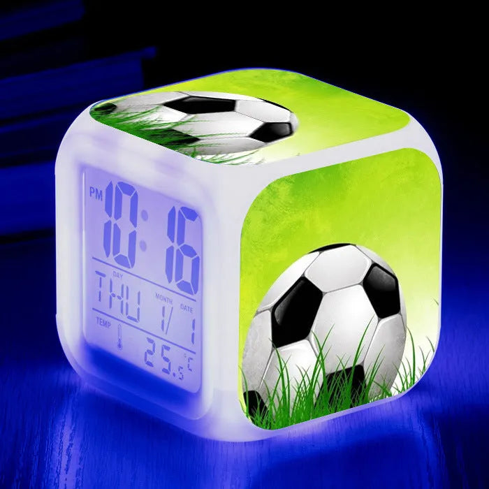 Square cartoon alarm clock with a football pattern design, showing a four-sided mute alarm for children.