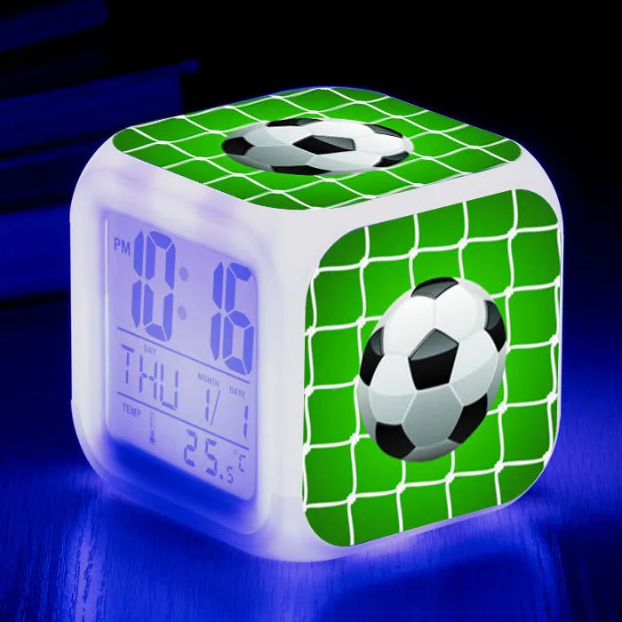 Square cartoon alarm clock with a football pattern design, showing a four-sided mute alarm for children.