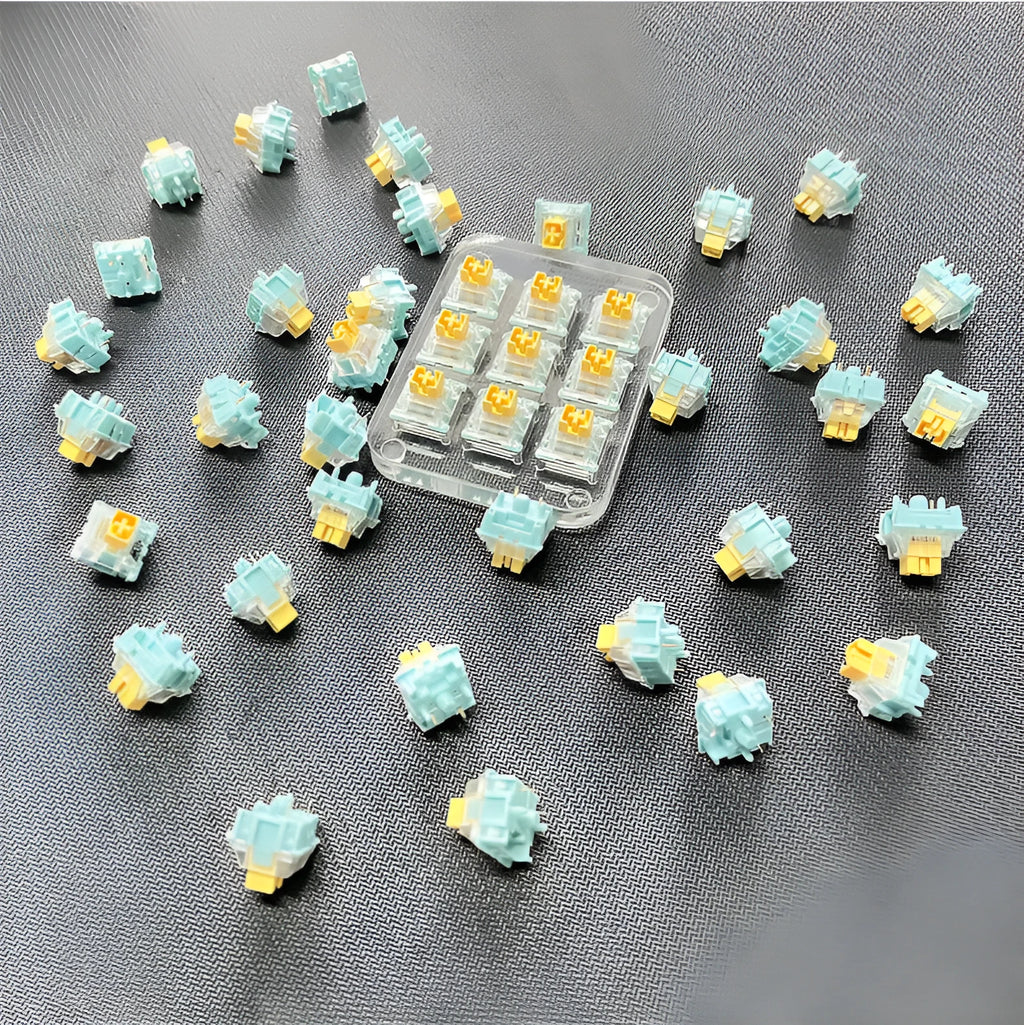 36 Sea Salt Lemon coloured PRO Mute mechanical keyboard switches laid out on a surface.