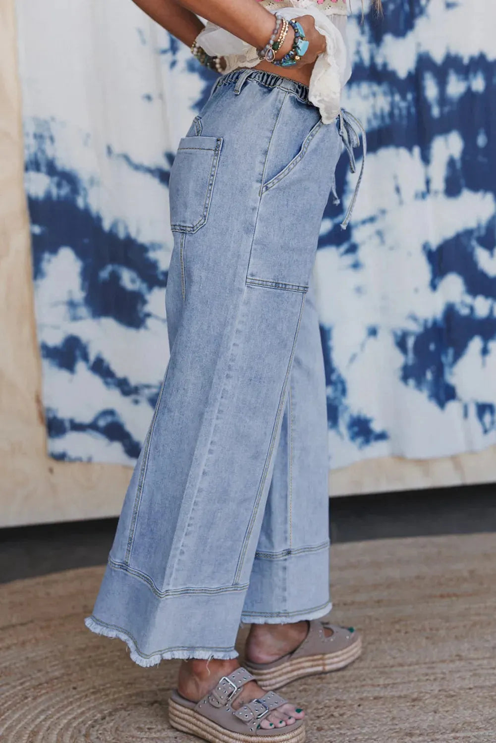 Beau blue wide leg denim trousers with drawstring waist and raw hem detail