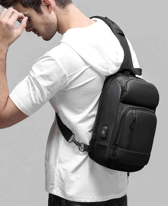 Black PVC outdoor leisure shoulder bag with air cushion strap showing organisational pockets