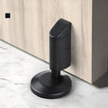 Modern zinc alloy door stopper in brushed nickel finish on a wooden floor.