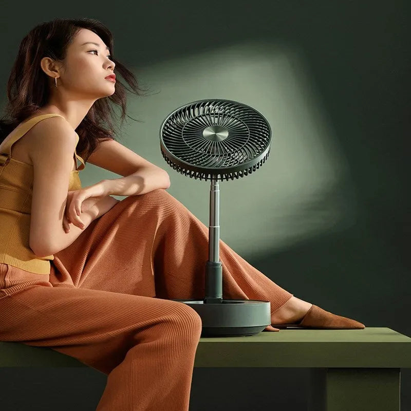 Green telescopic floor fan extended to vertical position with remote control